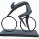 Abstract geometric sculpture of a cyclist in a forward‑leaning racing position on circular wheels