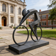 Modern cyclist sculpture featuring angular body shapes and minimalist bicycle design