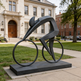 Abstract bicycle sculpture with a streamlined rider and clean geometric composition