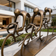 Bronze sculpture of cyclists in a modern outdoor setting