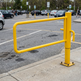 Surface-mounted bright yellow commercial steel P gate barrier featuring a swing bar and post base for controlling vehicle access in parking areas and trailways.
