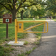 Commercial-grade steel safety swing gate with rugged mounting posts and latch