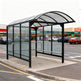 Side profile of TAIMCO shopping cart shelter featuring transparent polycarbonate panels and heavy‑duty metal supports.