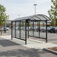 Interior of shopping cart shelter showing steel railing system and weather‑protected polycarbonate enclosure.