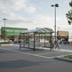 Rear angle of drum‑style shopping cart shelter with enclosed sides and open front entry.