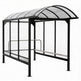 Drum‑style shopping cart shelter with curved polycarbonate roof and black steel frame by TAIMCO.