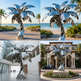 Highly polished metal palm tree artwork with stylized broad leaves and a circular base.
