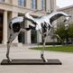 Contemporary metal sculpture of a stylized horse with open sections and a minimal rider