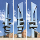Polished metallic abstract structure featuring layered geometric forms with clean reflective planes