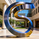 Modern metallic sculpture with twisting ribbon geometry and reflective highlights