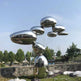Contemporary reflective sculpture featuring stacked rounded metal forms with smooth contours