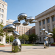 Contemporary polished metal artwork composed of rounded reflective shapes stacked vertically
