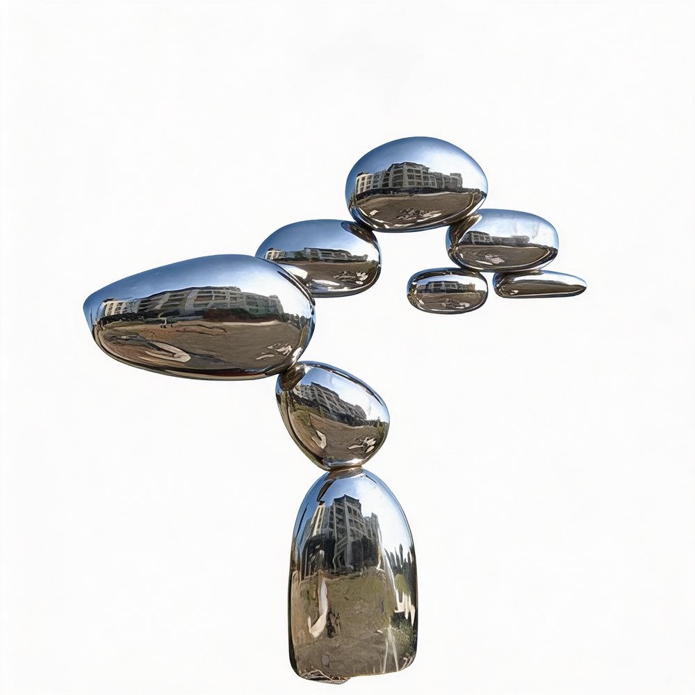 Sculptural tower of reflective pebble shapes crafted from polished metal