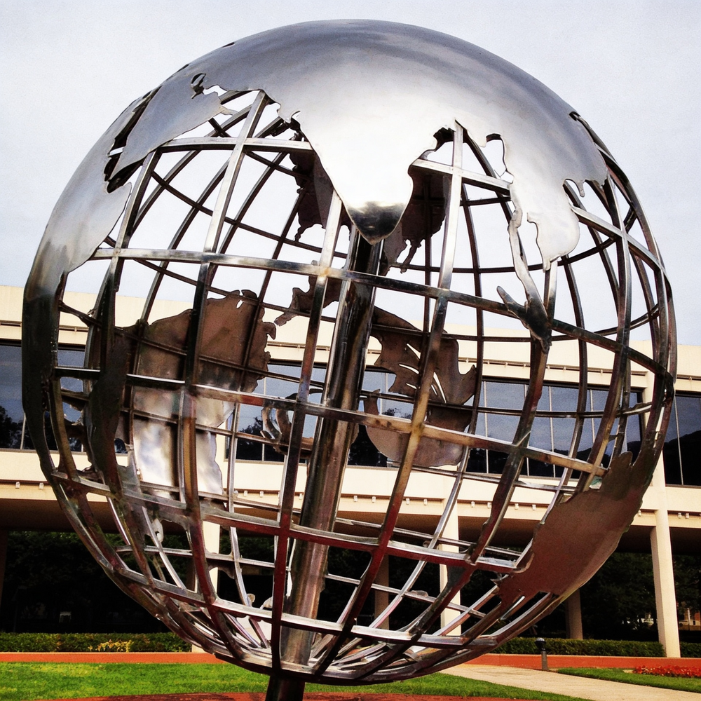Metallic globe artwork with polished surfaces and stylized geographic continent pieces