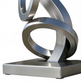Metallic sculpture with interlocking rings on a white background