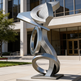 Modern metal sculpture in front of a building
