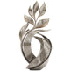 Polished metal abstract sculpture with engraved leaf‑flame forms and ornate swirling patterns
