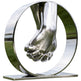 Metallic sculpture of two interlocked hands within a circular frame on a white background