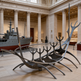 Abstract polished metal sculpture with upward‑reaching elements arranged in a vessel‑like formation