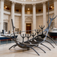 Sleek metallic sculpture with smooth curved forms rising in a ship‑like abstract pattern