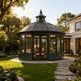 Freestanding round conservatory with 360‑degree glass enclosure