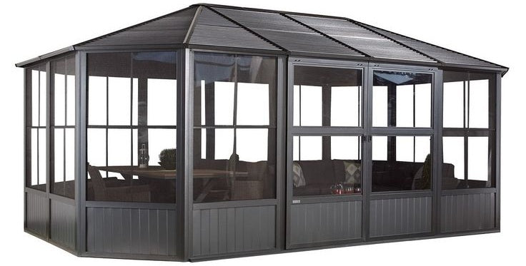 Modern enclosed outdoor pavilion with pitched roof and clear wall panels