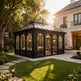 Elegant Victorian greenhouse structure with arched windows and metal framing