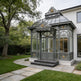 Luxury estate conservatory with raised center roof and decorative panels