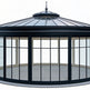 Circular glass pavilion with conical roof and raised crown