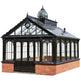 Victorian-style glasshouse with black frame and brick base on a white background