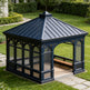 Blue garden gazebo with lattice design on a grassy lawn