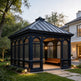Black hexagonal gazebo with lattice design in a garden setting.