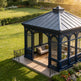 Blue gazebo with outdoor furniture in a garden setting