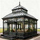Large ornate glasshouse with a domed roof in a garden setting