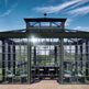 Glasshouse with a black frame against a blue sky