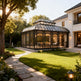Orangery attached to a modern house with a well-maintained garden.