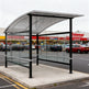 Interior of TAIMCO shopping cart shelter with stainless steel railings for organized cart storage.