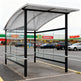 Close‑up of curved perforated metal roof on TAIMCO shopping cart shelter showing ventilation and weather protection.