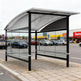Empty modern shopping cart shelter with perforated roof and glass panels designed for retail stores.