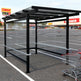 Precision‑welded black steel frame detail on TAIMCO shopping cart shelter.