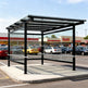 Rear angle of modern shopping cart shelter with clear side panels and open front entry.