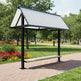 Empty modern bench shelter with steel frame and metal roof, designed for parks and public areas.
