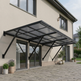 Patio cover attached to a house with potted plants on a stone patio