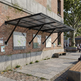 Outdoor setting with a brick building, awning, and city map on a wall.
