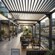 Outdoor seating area with canopies and tables in an urban setting