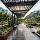 Modern outdoor walkway with pergolas and greenery in an urban setting