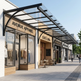 Outdoor shopping area with 'Avenue Apparel' and 'Café Luna' stores under a glass canopy.