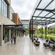 Modern university campus with students in an outdoor seating area.