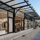 Modern street view with a row of shops including 'Artisan Brews' and 'Avenue'.