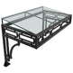 Black metal coffee table with glass top on a white background